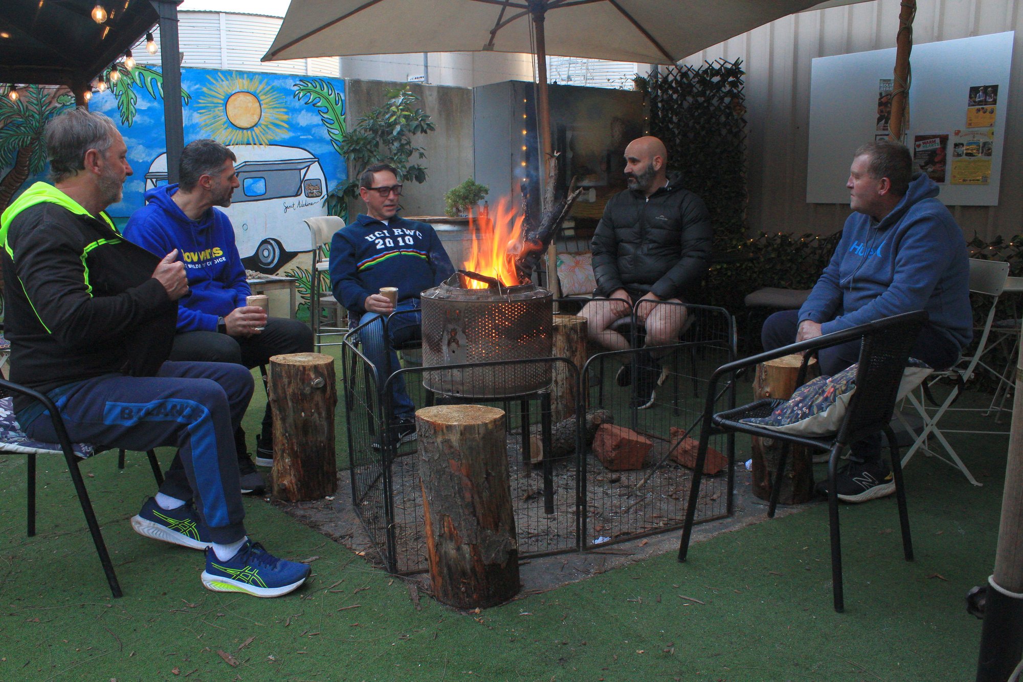 Blokes around the fire pit at a coffee catch-up