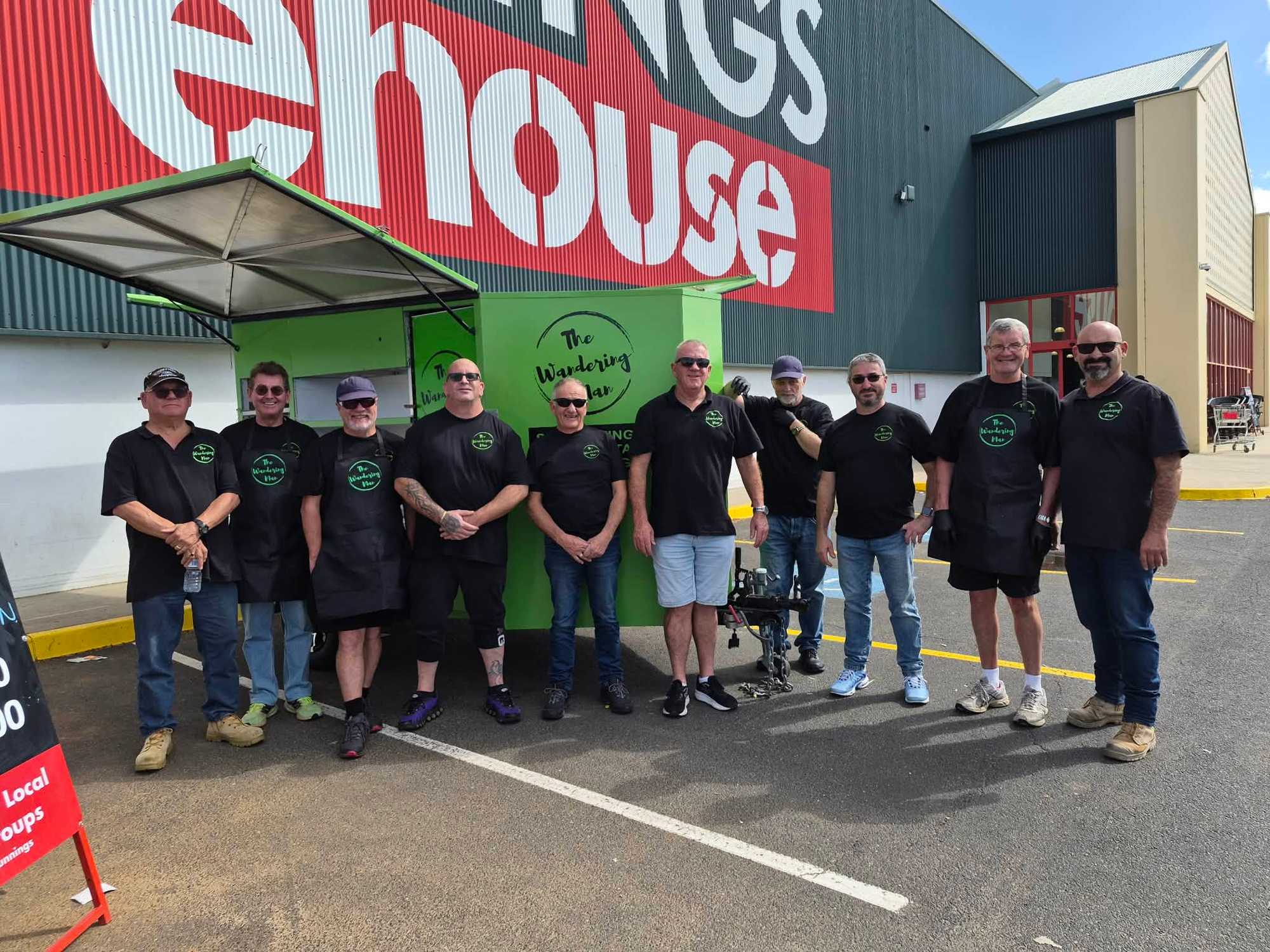 The crew posing in front of the Wandering Man BBQ trailer at Bunnings